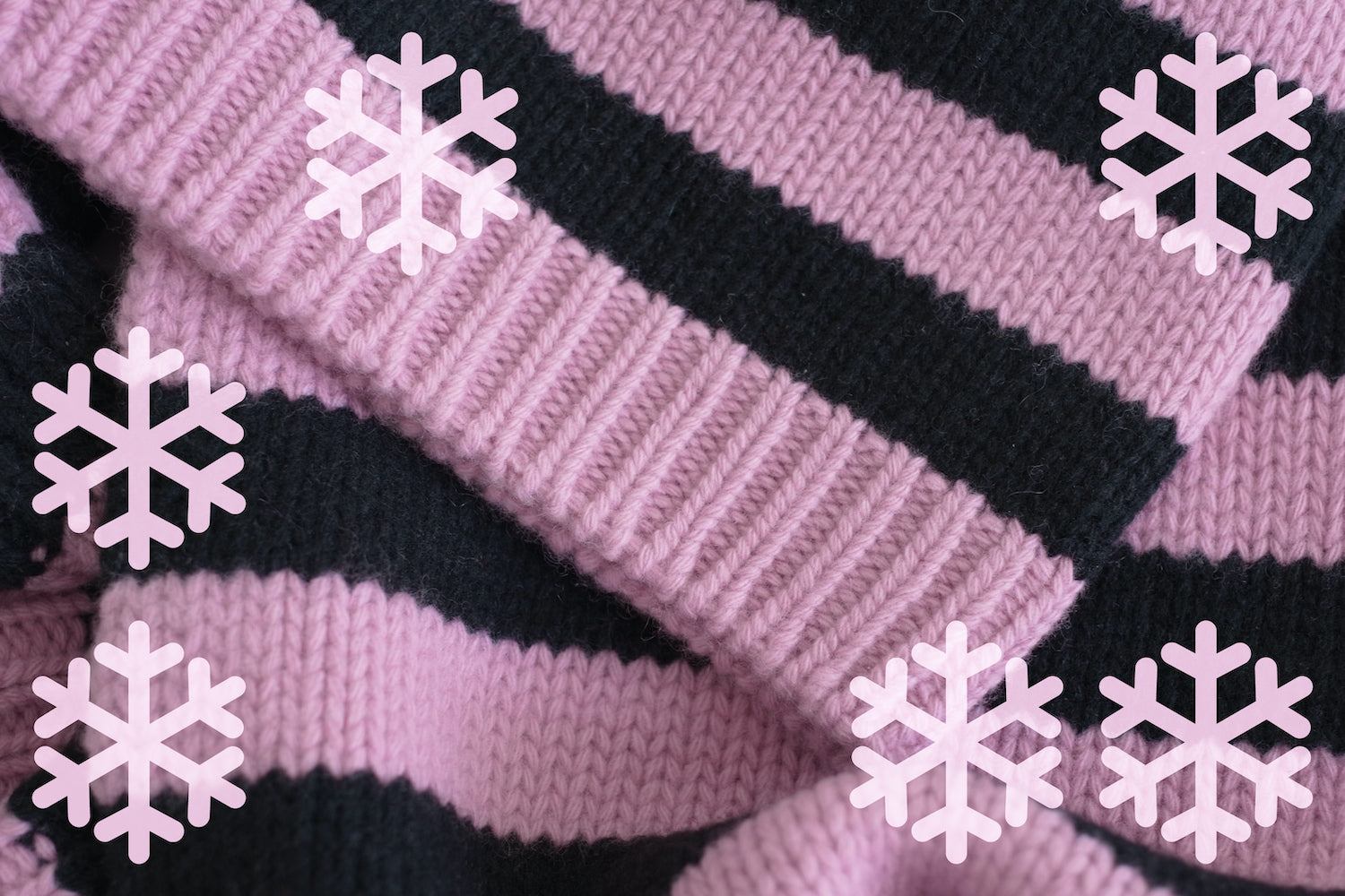 Close-up of pink and black striped fabric with snowflake patterns