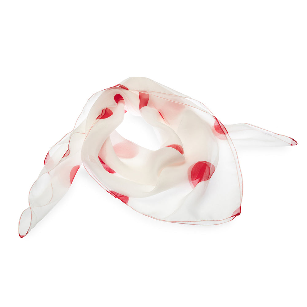 White scarf with red polka dots on a white background