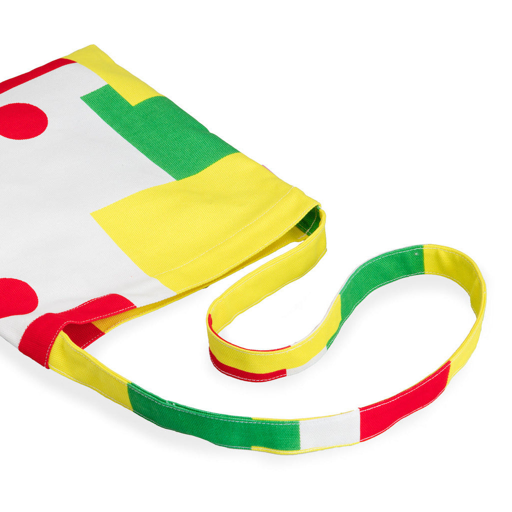 Colorful striped bag with a yellow strap on a white background