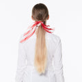 Maria wearing with a ponytail wearing a silk scarf race leader on a white background