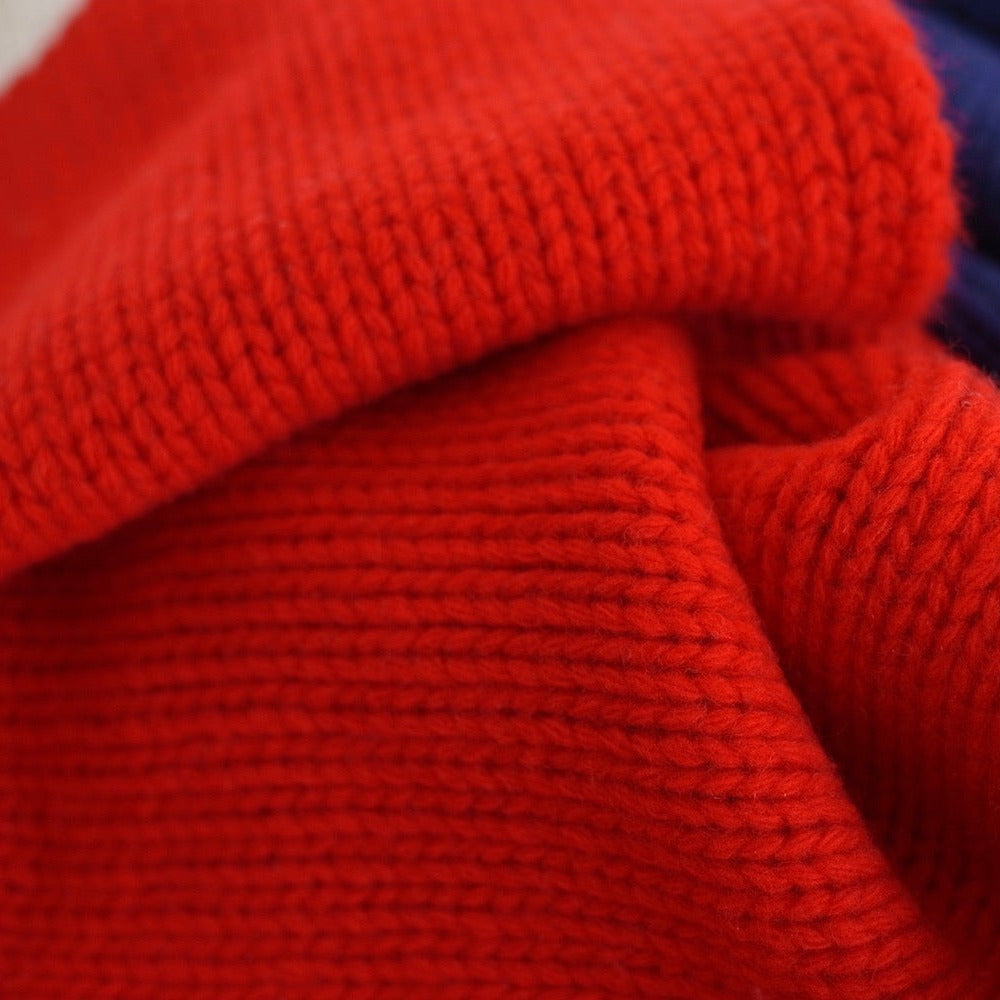 Close-up of a folded multicolored fabric with white, blue and red sections.