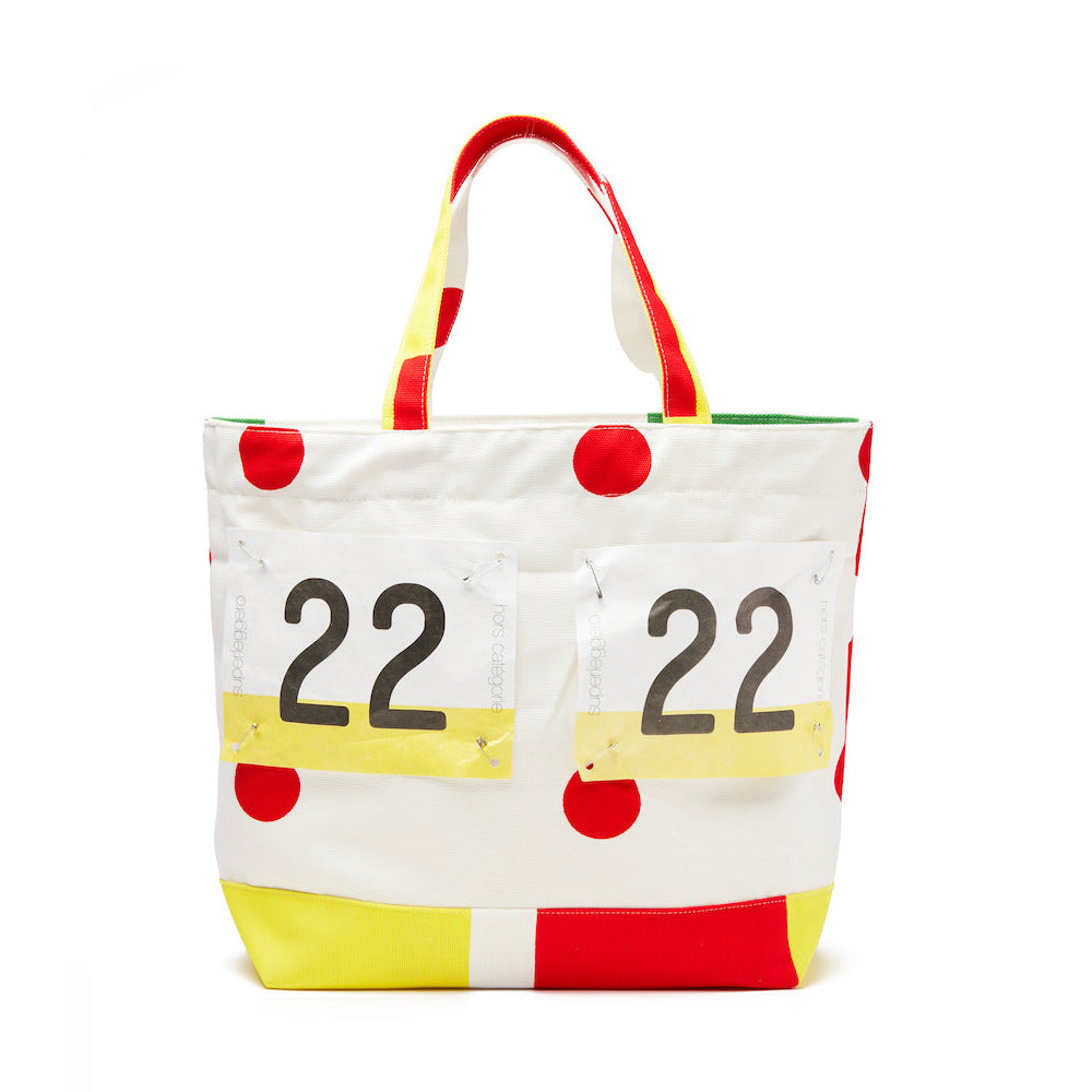 Tote bag with red polka dots, number 22, and yellow accents on a white background