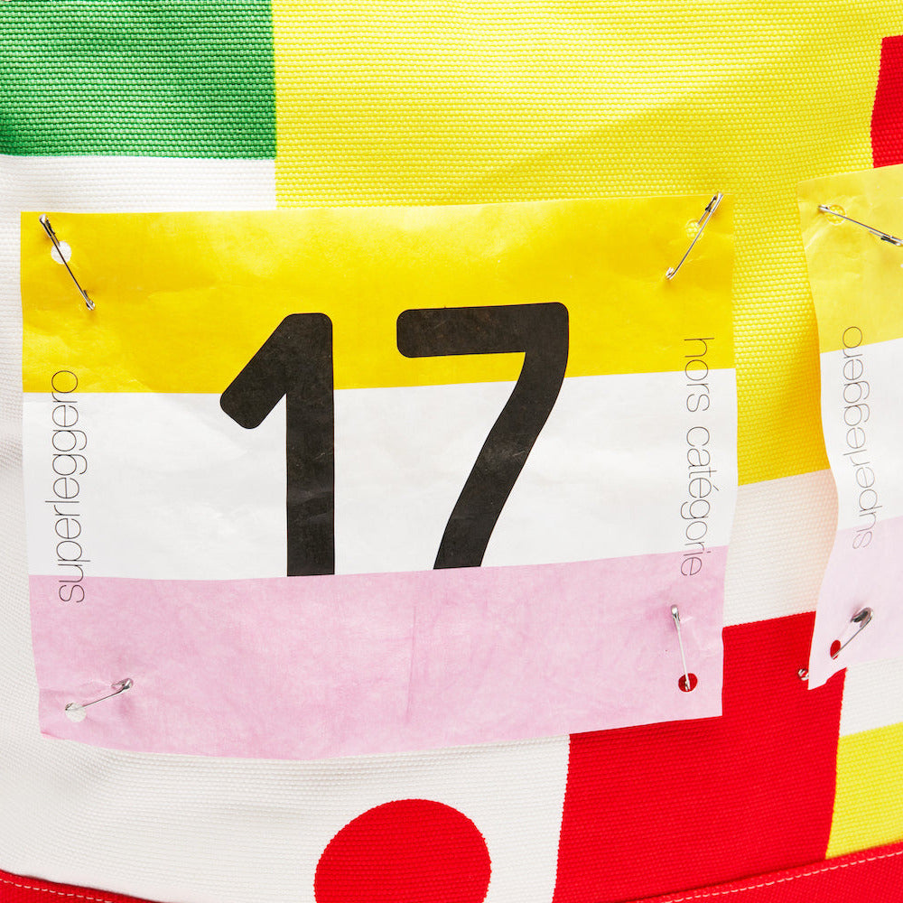 White tote bag with number 17 with red polkadots and green and yellow accents, featuring Superleggero branding.
