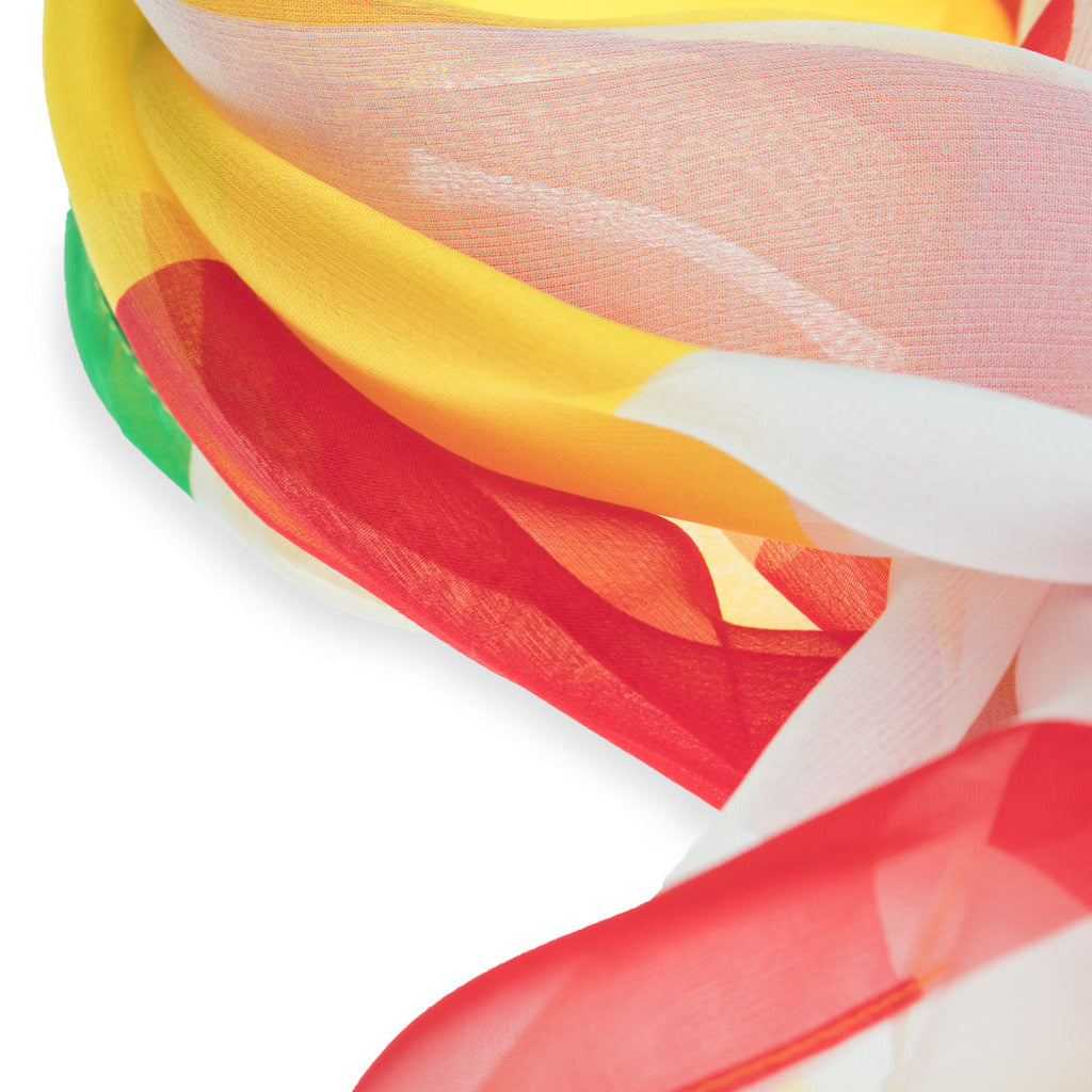Close-up of colorful silk foulard with red, yellow, green, and white colors on a white background.