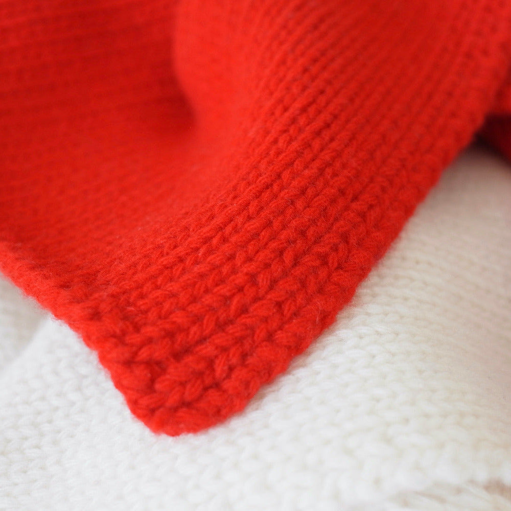 Close-up of a red knitted fabric on a white background