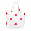 White tote bag with red polka dots on a white background