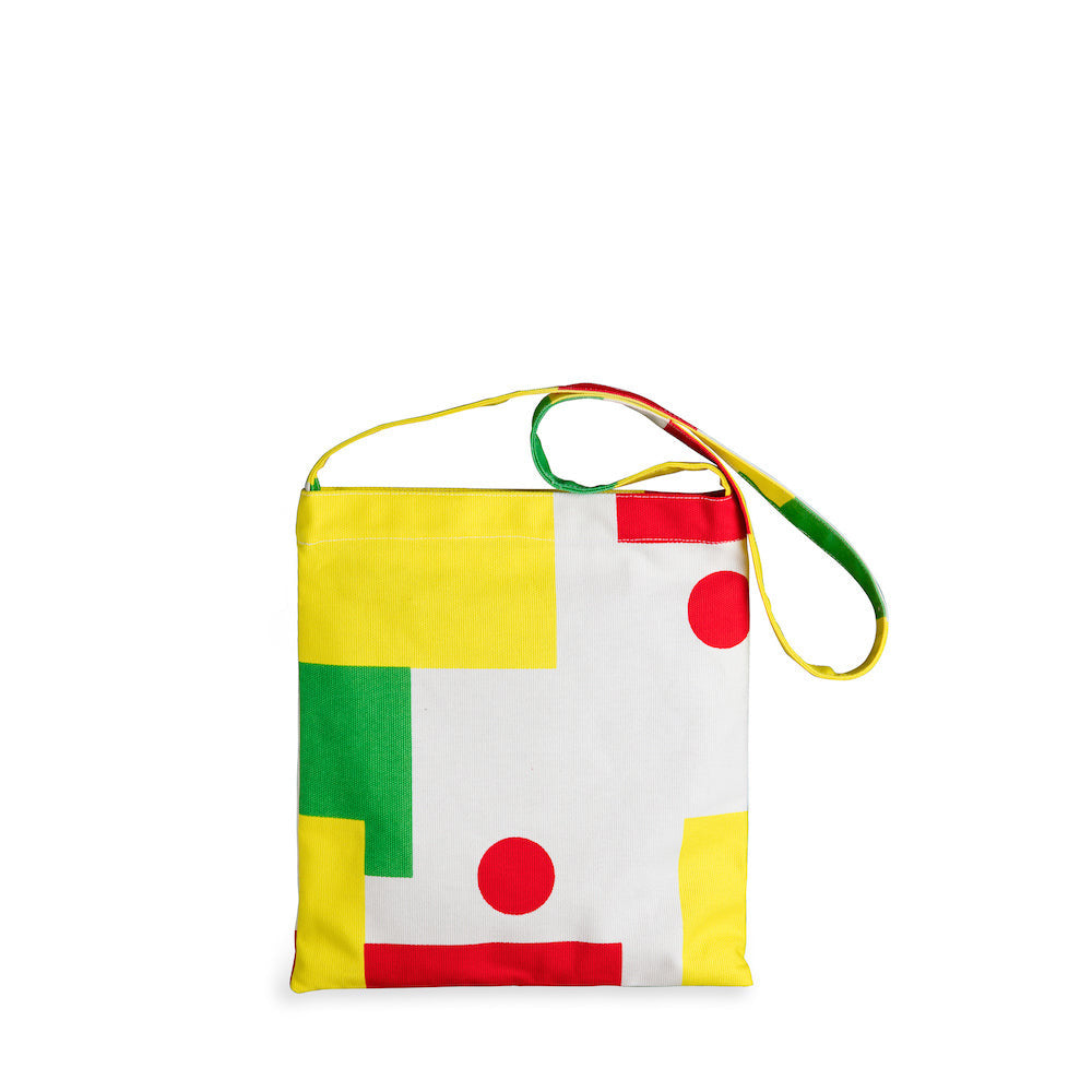 Colorful geometric patterned bag with a strap on a white background