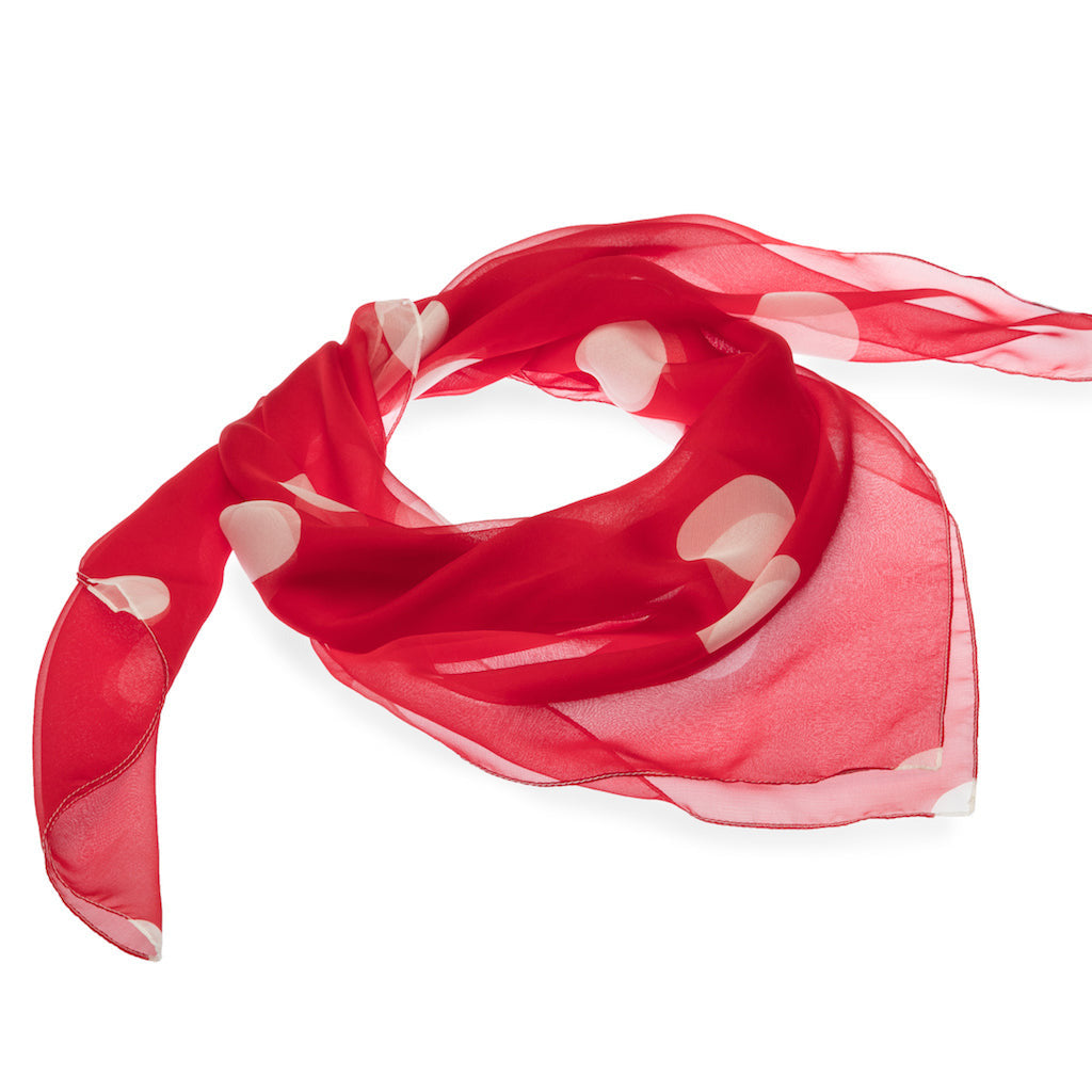 Red silk scarf with white polka dots on a white background
